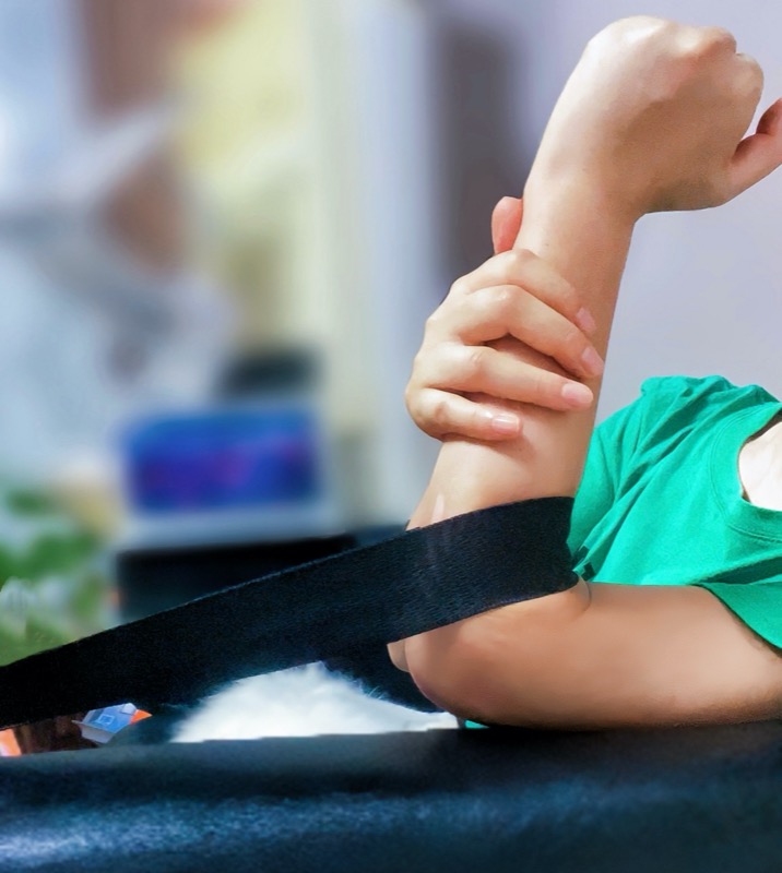 Close-up of resistance band placement on elbow joint for activation exercise